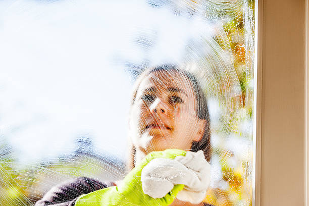 istock Young Woman Cleaning Windows 628517776