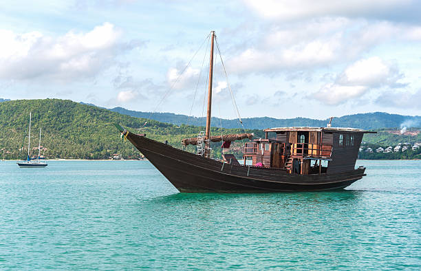 istock Beautiful old boat in the sea comes into bay. 628517814