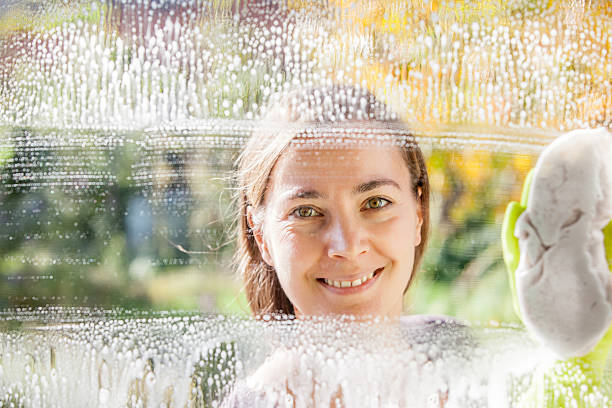 istock Young Woman Cleaning Windows 628517824