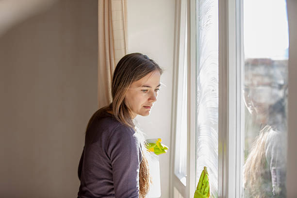 istock Young Woman Cleaning Windows 628517838