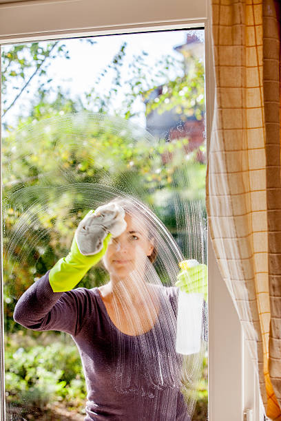 istock Young Woman Cleaning Windows 628517848