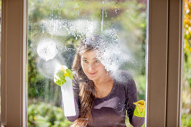 istock Young Woman Cleaning Windows 628517858