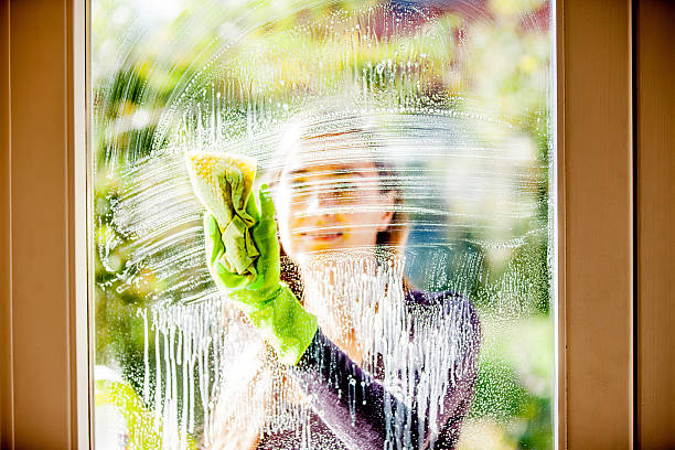 istock Young Woman Cleaning Windows 628517864