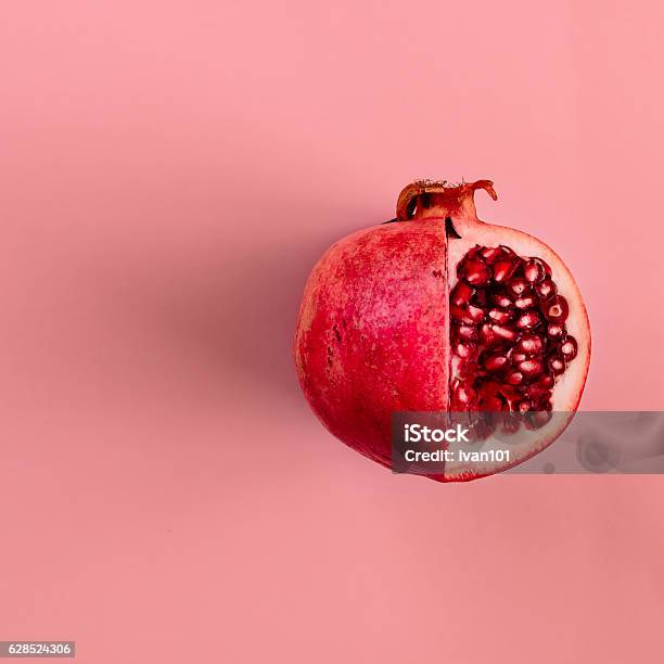 Red Pomegranate Fruit On Pastel Pink Background Minimal Flat La Stock Photo - Download Image Now