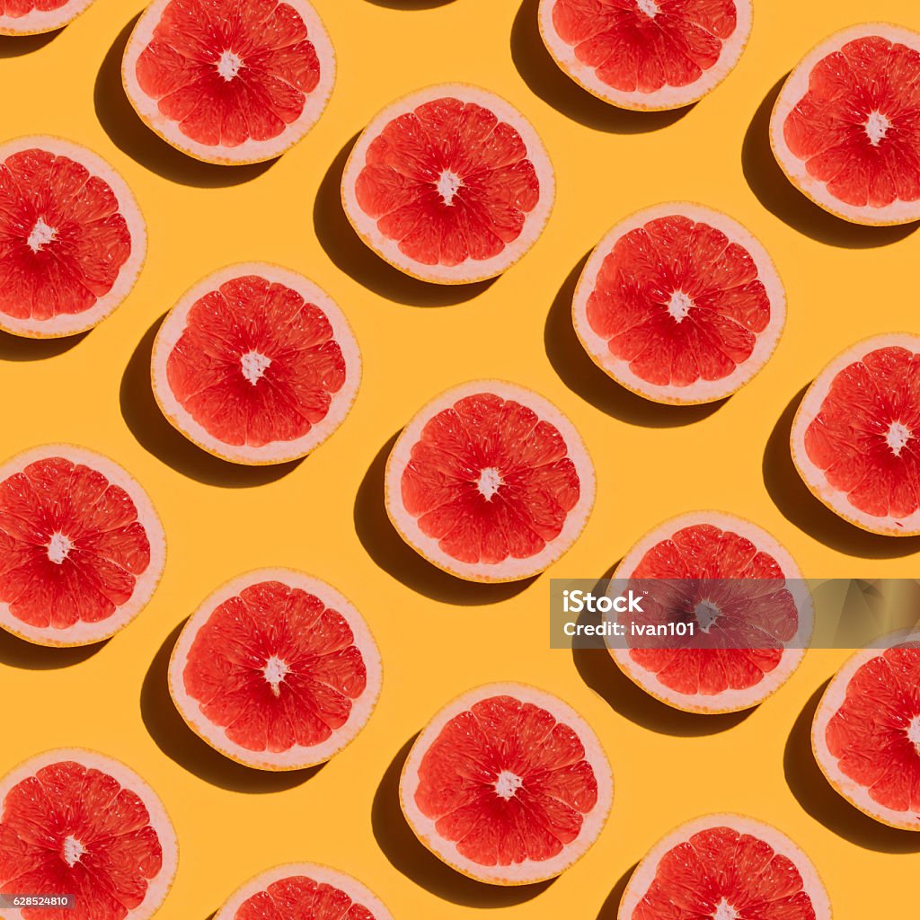 Grapefruit pattern on yellow background. Minimal flat lay concep Grapefruit pattern on yellow background. Minimal flat lay concept. Grapefruit Stock Photo