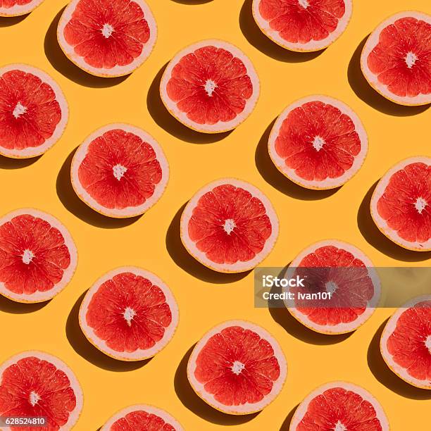 Grapefruit Pattern On Yellow Background Minimal Flat Lay Concep Stock Photo - Download Image Now