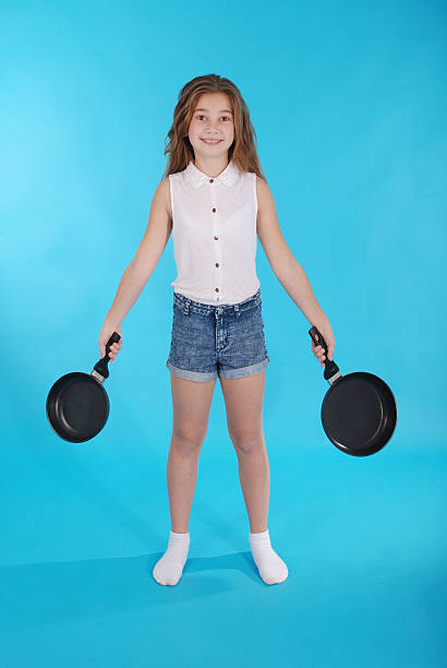istock Young girl with a frying pan 628526898