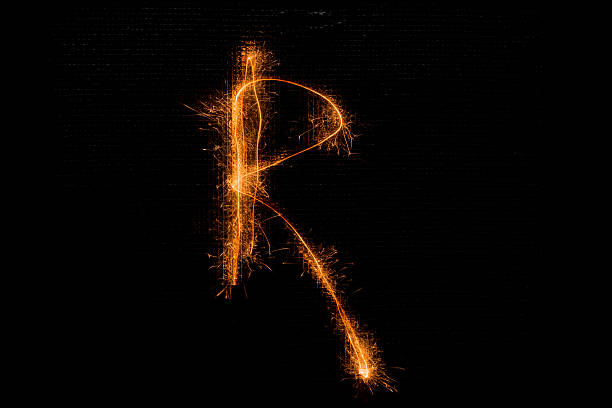istock Letter R made of sparklers on black 628526900