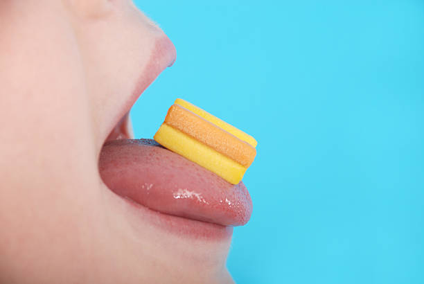 Close up on a beautiful girl while enjoying a chewing gum on blue