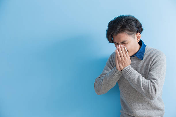istock man is sick and sneezing 628527380