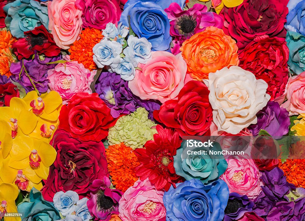 Beautiful multicolored artificial flowers background. Beautiful multicolored artificial flowers background. flowers decor. Multi Colored Stock Photo