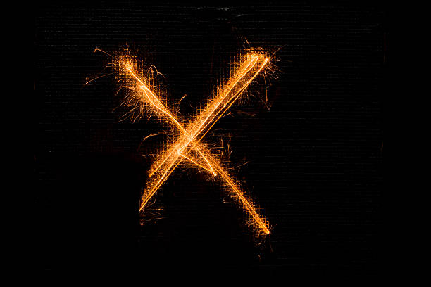 istock Letter X made of sparklers on black 628528940