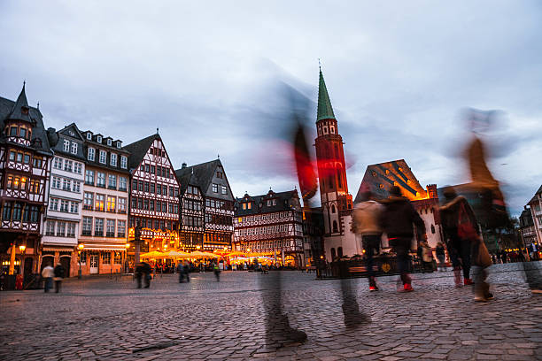 istock People in Frankfurt old town square at dusk 628530082