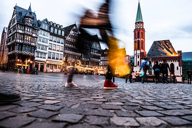 People in Frankfurt old town square at dusk