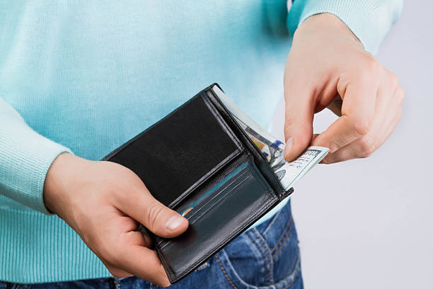 istock man holding a wallet with money 628535160