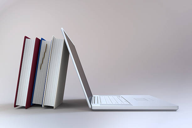 istock Books vs. Laptop Concept On Whitish Background 628536564