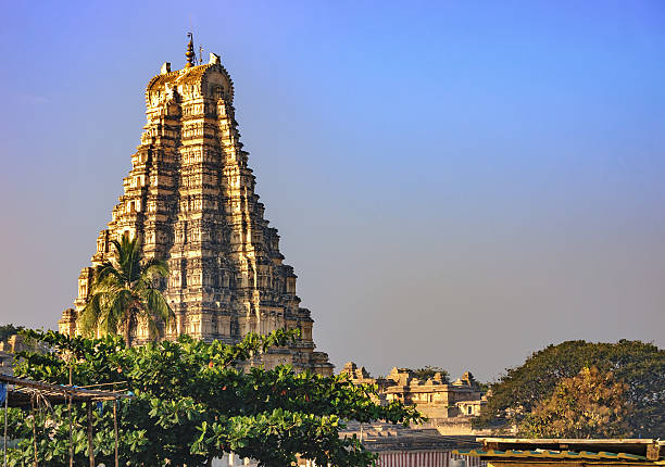 View of the Virupaksha temple from Hampi, India. Virupaksha Temple, located in the ruins of ancient city Vijayanagar at Hampi, India. View from Hampi. It is part of the Group of Monuments at Hampi, designated a UNESCO World Heritage Site. virupaksha stock pictures, royalty-free photos & images