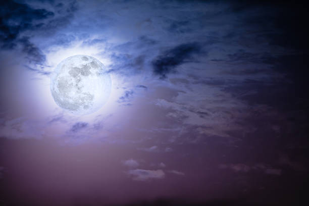 istock Nighttime sky with clouds and bright full moon with shiny. 628537078