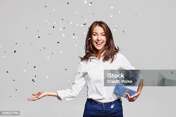 Laughing Girl With Falling Confetti At Party Stock Photo - Download Image Now - Gift, Women, People