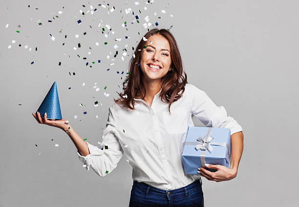 istock Laughing girl with falling confetti at party 628537804