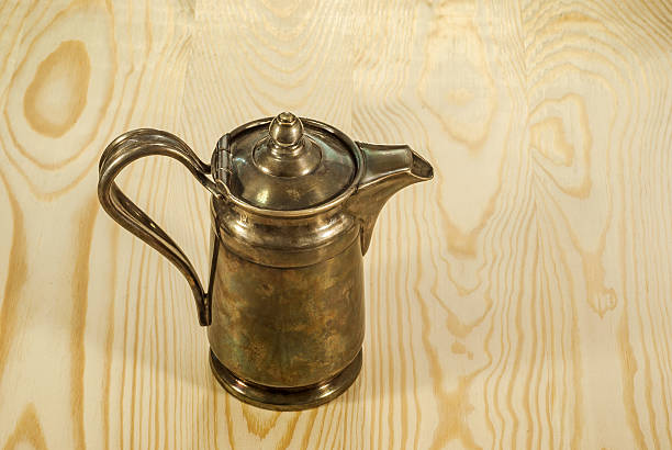istock Old coffee pot on a background of polished wood 628538330