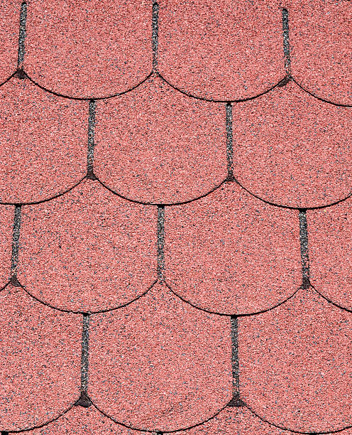 istock Roof with red bitumen shingles closeup 628541082