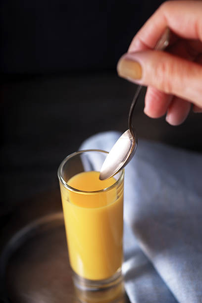 istock Egg liqueur  in the glass with spoon in the hand 628548968