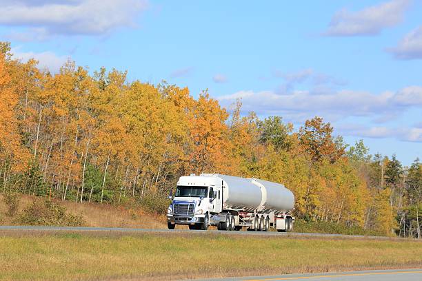 istock Semi tanker on an interstate highway, trees in background. 628551126