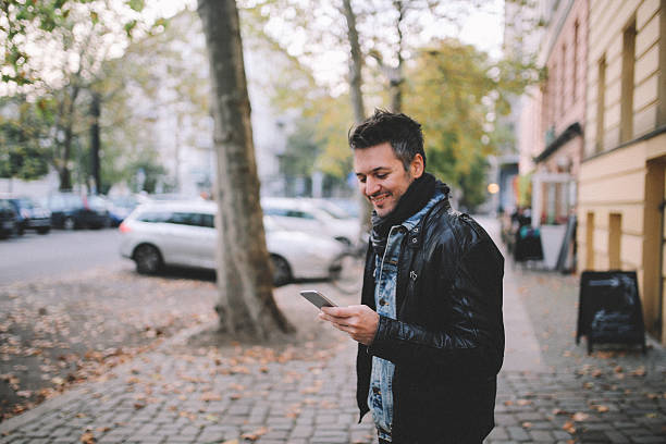 istock Young man checking cellphone in Berlin Prenzlauer Berg 628560300