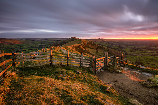 istock Sunrise sunlight shining on countryside gate Peak District. 628561860