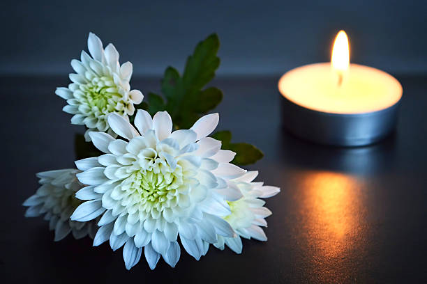 Candle and white flowers Candle and white flowers memorial vigil stock pictures, royalty-free photos & images