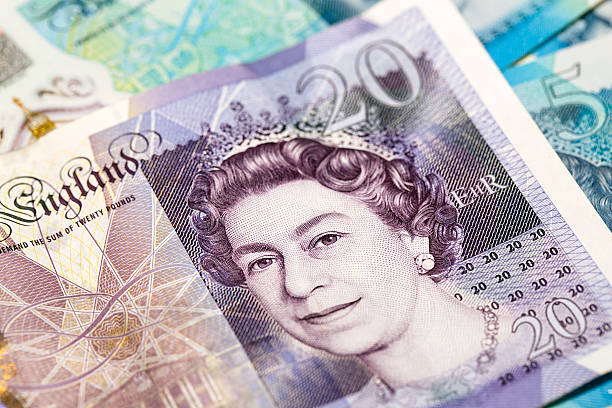 Twenty Pound Note - Close -up Swansea, UK: December 09, 2016: Close up of a British twenty pound note, showing the head of Queen Elizabeth II. Five pound notes can be seen behind,  british royalty photos stock pictures, royalty-free photos & images