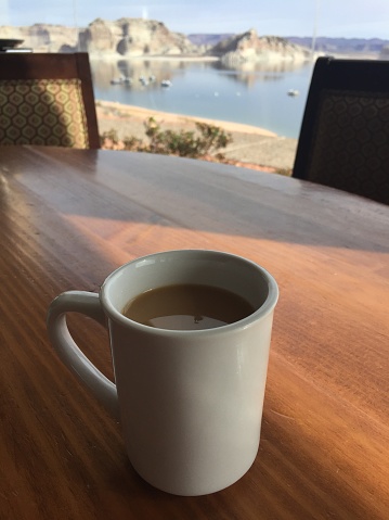 white coffee mug at a peaceful spot with Lake views.