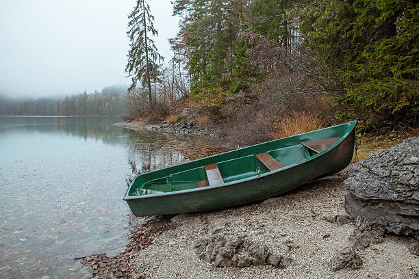 boat at lake coast in fog
