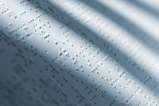 Braille white page of book with text