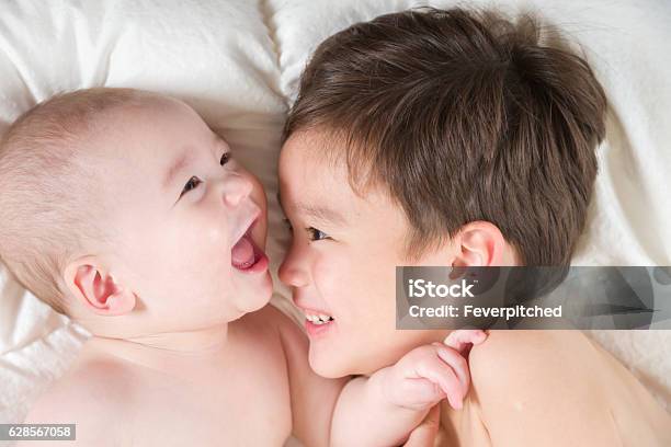 Mixed Race Chinese And Caucasian Baby Brothers Having Fun Laying Stock Photo - Download Image Now