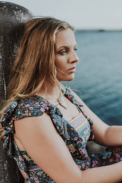 istock Young woman by the sea 628579178