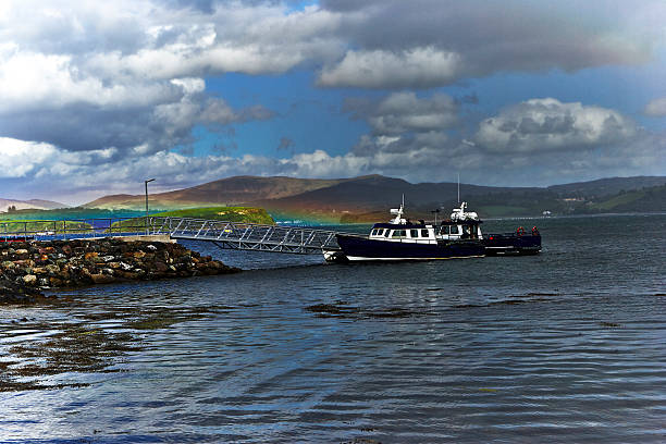 Rainbow descending over the boat dock at Whiddy Island, Bantry Bay Ireland