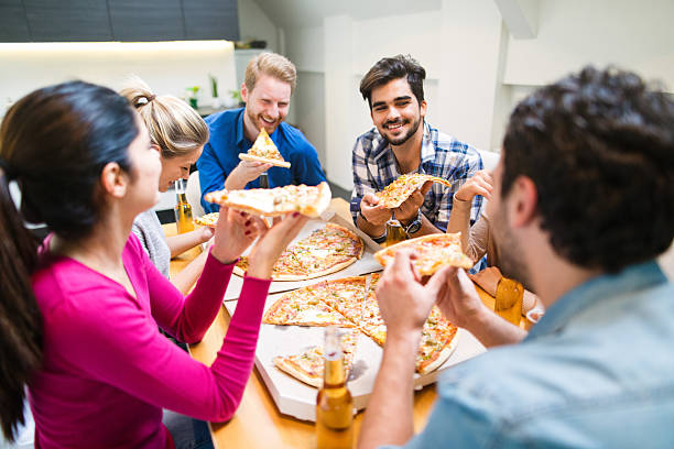 istock Friends having party with pizza, beer and good company 628592016