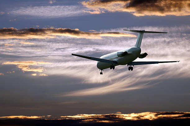 istock passenger jet plane flying in the evening sky at sunset 628592042