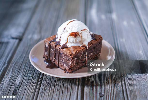 Chocolate Fudgy Brownie With Vanilla Ice Cream On Top Stock Photo - Download Image Now