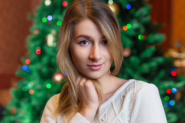 Beautiful woman portrait.,christmas tree lights background. happ Beautiful sexy young blonde girl with hair in white sweater, a holiday New Year Christmas joy fun happ stock pictures, royalty-free photos & images