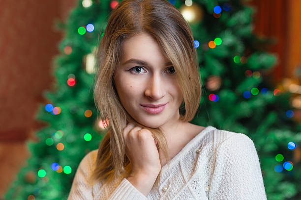 Beautiful woman portrait.,christmas tree lights background. happ Beautiful sexy young blonde girl with hair in white sweater, a holiday New Year Christmas joy fun happ stock pictures, royalty-free photos & images