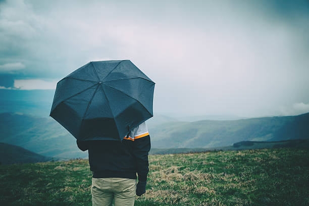 istock Man in nature holding umbrella. 628603790
