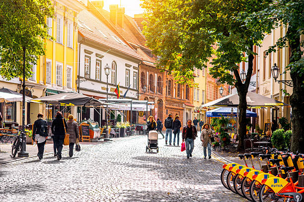 Street view in Vilnius Vilnius, Lithuania - September 21, 2016: Tourists walk on the main pedestrian street with cafes and bars in the old town of Vilnius city lithuania photos stock pictures, royalty-free photos & images