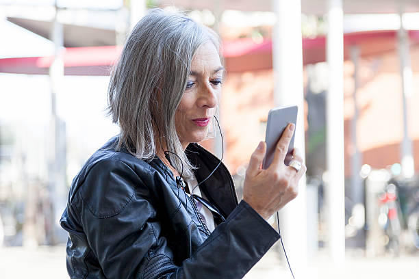 istock elegant lady consults smartphone waiting for the train 628606116