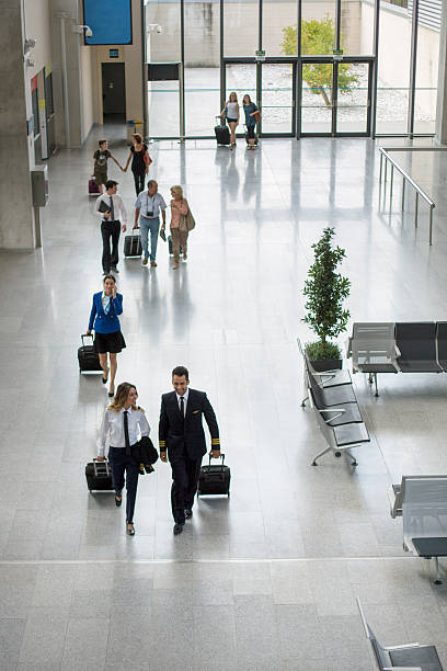 istock Passengers and crew walking through airport 628606854
