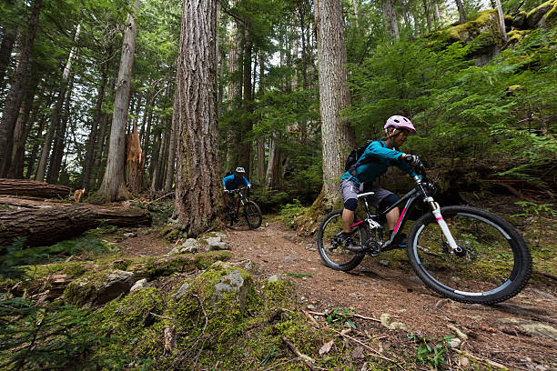 istock Couple biking in an old growth forest 628607820