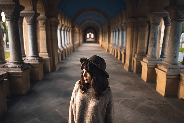 A young woman at a beautiful cloister.