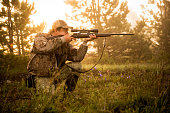 Hunter shooting with rifle